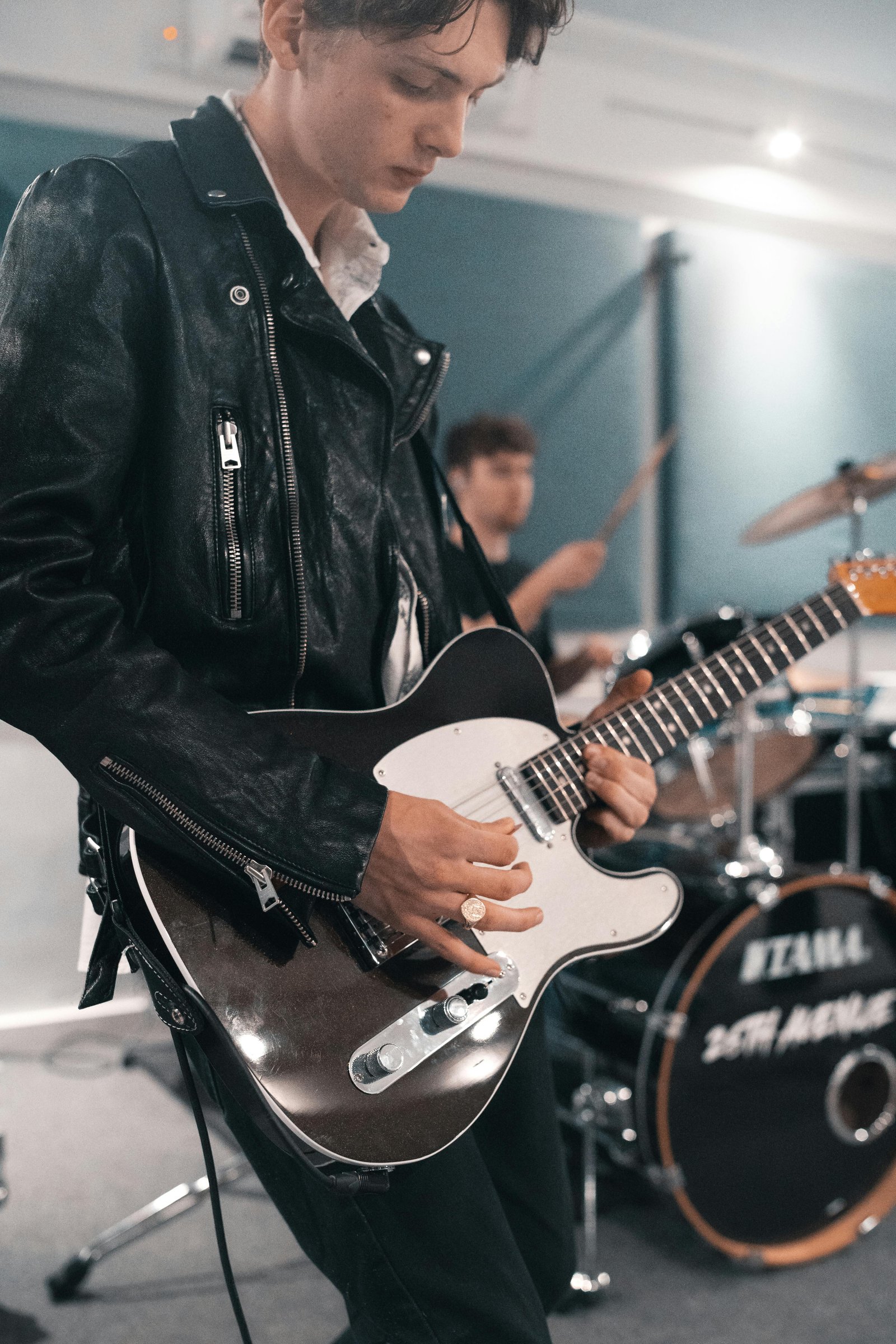 live band guitarist performing with a drum kit