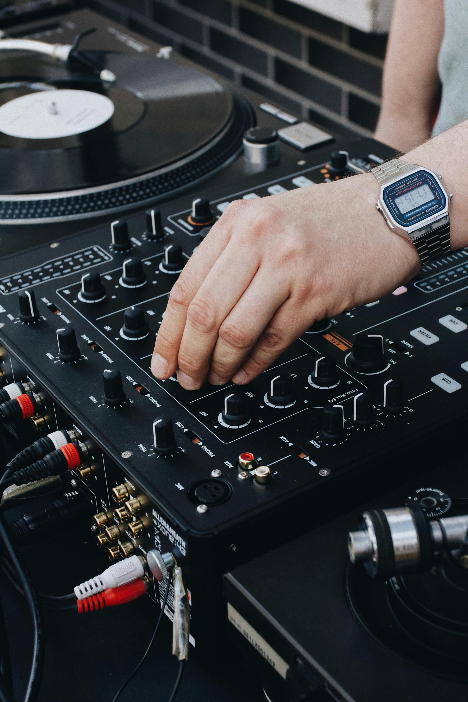 DJ mixing music on a professional DJ console