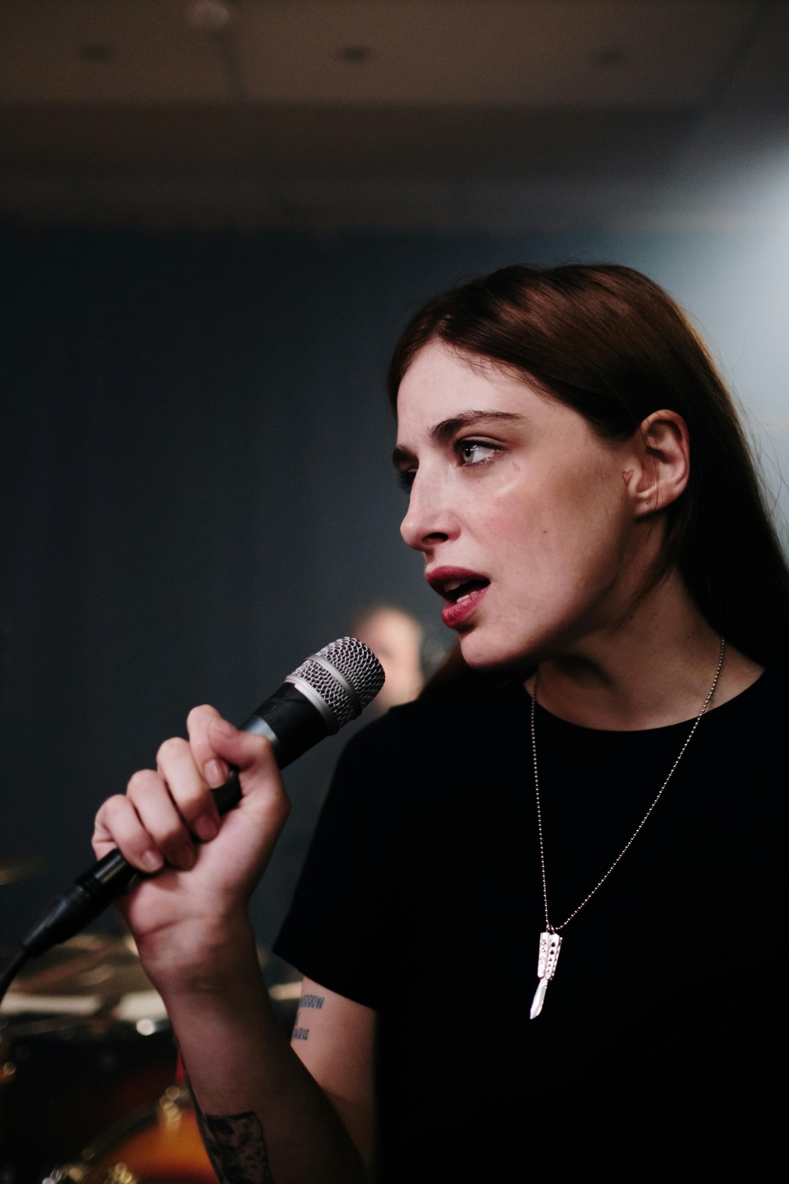 female singer performing live with a microphone